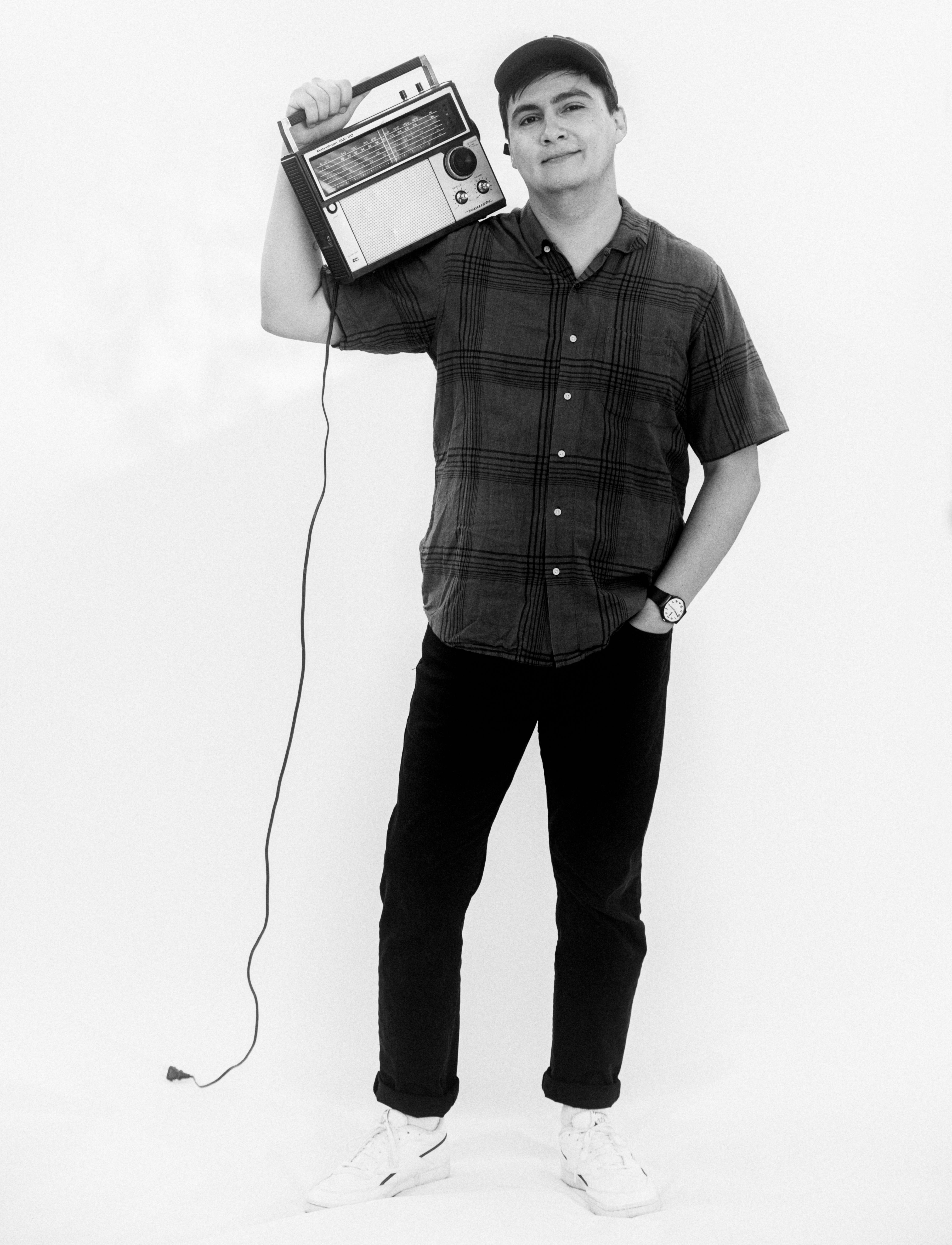 profile picture of Miguel hoisting a radio on his shoulder. photo by Meesh Deyden